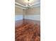 This dining room offers hardwood flooring, decorative trim, a modern chandelier and neutral paint at 5010 Lynnonhall Ct, Stonecrest, GA 30038