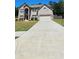 Traditional two-story brick home with an attached two-car garage and a long driveway at 5010 Lynnonhall Ct, Stonecrest, GA 30038