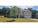 Charming two-story home with a brick facade, arched entryway, and lush green lawn at 5010 Lynnonhall Ct, Stonecrest, GA 30038