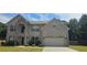 Attractive two-story home with a brick facade, arched entryway, and well-maintained lawn at 5010 Lynnonhall Ct, Stonecrest, GA 30038