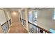 The home features an upstairs hallway with wood and wrought iron railings and neutral paint at 5010 Lynnonhall Ct, Stonecrest, GA 30038