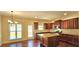 Modern kitchen with granite countertops, dark wood cabinets, stainless appliances, and hardwood floors at 5010 Lynnonhall Ct, Stonecrest, GA 30038