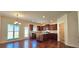 Modern kitchen with wood floors, brown cabinets, stainless appliances, and an island at 5010 Lynnonhall Ct, Stonecrest, GA 30038