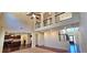 Bright living room with hardwood floors, high ceilings, open concept, and an adjacent kitchen at 5010 Lynnonhall Ct, Stonecrest, GA 30038