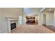 Inviting living room featuring a cozy fireplace and an open layout connecting to the kitchen at 5010 Lynnonhall Ct, Stonecrest, GA 30038