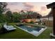 Stunning backyard featuring a modern pool with lounge chairs and elegant landscaping at 5360 Lake Forrest Dr, Atlanta, GA 30342