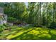A stunning backyard retreat featuring a pool, cabana, and expertly manicured lawn at 5360 Lake Forrest Dr, Atlanta, GA 30342