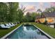 Beautiful backyard with a pool, lounge area, and lush greenery for relaxation at 5360 Lake Forrest Dr, Atlanta, GA 30342