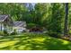 Beautiful backyard oasis with a modern pool, covered patio, and lush greenery at 5360 Lake Forrest Dr, Atlanta, GA 30342
