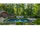 Gorgeous backyard with a pool, hot tub, sunbathing area, and an outdoor structure with fireplace at 5360 Lake Forrest Dr, Atlanta, GA 30342