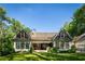 Stunning backyard featuring a covered porch and expansive lawn, perfect for outdoor living and entertaining at 5360 Lake Forrest Dr, Atlanta, GA 30342
