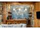Custom bar area featuring stone walls, wood accents, pendant lighting, and ample space for entertaining at 5360 Lake Forrest Dr, Atlanta, GA 30342