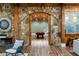Open basement space with custom stone archway, a pool table, and a bar area with stone and wood finishes at 5360 Lake Forrest Dr, Atlanta, GA 30342