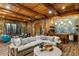 Finished basement with a stone accent wall, wet bar, comfortable seating, and wine storage at 5360 Lake Forrest Dr, Atlanta, GA 30342