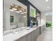 Modern bathroom featuring a double sink vanity with marble countertop and navy blue accent wall at 5360 Lake Forrest Dr, Atlanta, GA 30342
