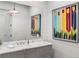 Stylish bathroom featuring a marble vanity, a framed mirror, and shiplap walls with a colorful painting at 5360 Lake Forrest Dr, Atlanta, GA 30342
