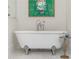 Close-up of a freestanding bathtub with vintage-style fixtures and silver claw feet at 5360 Lake Forrest Dr, Atlanta, GA 30342