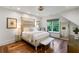 Bright bedroom with natural light, wood floors, paneled accent wall, and elegant decor at 5360 Lake Forrest Dr, Atlanta, GA 30342