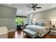 Serene bedroom with hardwood floors, a plush bed, and a seating area by the window at 5360 Lake Forrest Dr, Atlanta, GA 30342