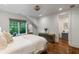 Bright bedroom with natural light, wood floors, paneled accent wall, and connecting bathroom at 5360 Lake Forrest Dr, Atlanta, GA 30342