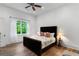 Inviting bedroom features hardwood floors, a ceiling fan, and large windows with backyard view at 5360 Lake Forrest Dr, Atlanta, GA 30342