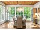 Elegant dining room with hardwood floors, a crystal chandelier, and large windows showcasing a green view at 5360 Lake Forrest Dr, Atlanta, GA 30342
