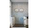 Tiled dog shower in laundry room with showerhead and framed pictures on the dog-themed wallpaper wall at 5360 Lake Forrest Dr, Atlanta, GA 30342