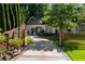 Charming home featuring a gated driveway and a well-maintained, landscaped yard at 5360 Lake Forrest Dr, Atlanta, GA 30342