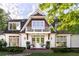 Classic two-story home with a balcony, white brick facade, and well-maintained landscaping at 5360 Lake Forrest Dr, Atlanta, GA 30342