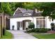 Exterior shot of home featuring a curved driveway, covered entry, and manicured landscaping at 5360 Lake Forrest Dr, Atlanta, GA 30342