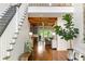 Spacious foyer with staircase, hardwood floors, wooden beams, and views to multiple rooms at 5360 Lake Forrest Dr, Atlanta, GA 30342