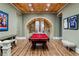 Spacious game room with custom wood ceiling, a large pool table, and ample room for entertaining at 5360 Lake Forrest Dr, Atlanta, GA 30342