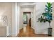 Bright hallway with hardwood floors, white trim, and decorative walls leading to various rooms at 5360 Lake Forrest Dr, Atlanta, GA 30342