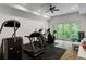 Spacious home gym with treadmill, elliptical, and access to the backyard through french doors at 5360 Lake Forrest Dr, Atlanta, GA 30342