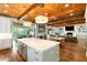 Open-concept kitchen with an island, stainless steel appliances, wood ceiling and hardwood floors at 5360 Lake Forrest Dr, Atlanta, GA 30342