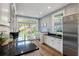 Bright laundry room with black countertop, stainless steel appliances, subway tile, and dog-themed wallpaper at 5360 Lake Forrest Dr, Atlanta, GA 30342