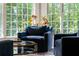 Cozy sitting area featuring chairs, natural light, and views of the surrounding greenery at 5360 Lake Forrest Dr, Atlanta, GA 30342