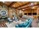 Inviting living room featuring stone and wood accents, comfortable seating, and a custom bar area at 5360 Lake Forrest Dr, Atlanta, GA 30342