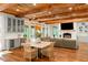 Open-concept living room featuring a cozy fireplace, hardwood floors, and a bar area with wine storage at 5360 Lake Forrest Dr, Atlanta, GA 30342