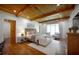 Spacious main bedroom featuring hardwood floors, wood ceiling beams, and a cozy seating area at 5360 Lake Forrest Dr, Atlanta, GA 30342