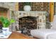 Stone fireplace featuring a wood storage area, wood burning fire and mantel at 5360 Lake Forrest Dr, Atlanta, GA 30342