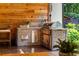 Outdoor kitchen with a built-in grill and barstool seating at 5360 Lake Forrest Dr, Atlanta, GA 30342
