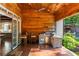Outdoor kitchen with a grill, counter space, and wood ceiling at 5360 Lake Forrest Dr, Atlanta, GA 30342