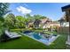 Luxury home showcasing a modern pool, surrounded by lush greenery and chaise lounges for relaxing at 5360 Lake Forrest Dr, Atlanta, GA 30342