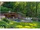 Backyard pool featuring a spa, covered pavilion with a fireplace, and lush landscaping for privacy at 5360 Lake Forrest Dr, Atlanta, GA 30342