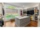 Spacious walk-in closet with a central island, custom shelving, and a window overlooking the yard at 5360 Lake Forrest Dr, Atlanta, GA 30342