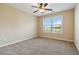Bright bedroom with a ceiling fan and a large window that provides ample natural light and backyard views at 700 Ridgeway Ct, Canton, GA 30114