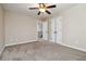 Comfortable bedroom with carpet, a ceiling fan, and convenient access to additional rooms at 700 Ridgeway Ct, Canton, GA 30114