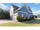 Side exterior showcasing garage, red shutters, manicured landscaping and blue shingle at 700 Ridgeway Ct, Canton, GA 30114