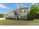 Charming two-story home with green siding, dark shutters and a well-manicured front yard at 700 Ridgeway Ct, Canton, GA 30114